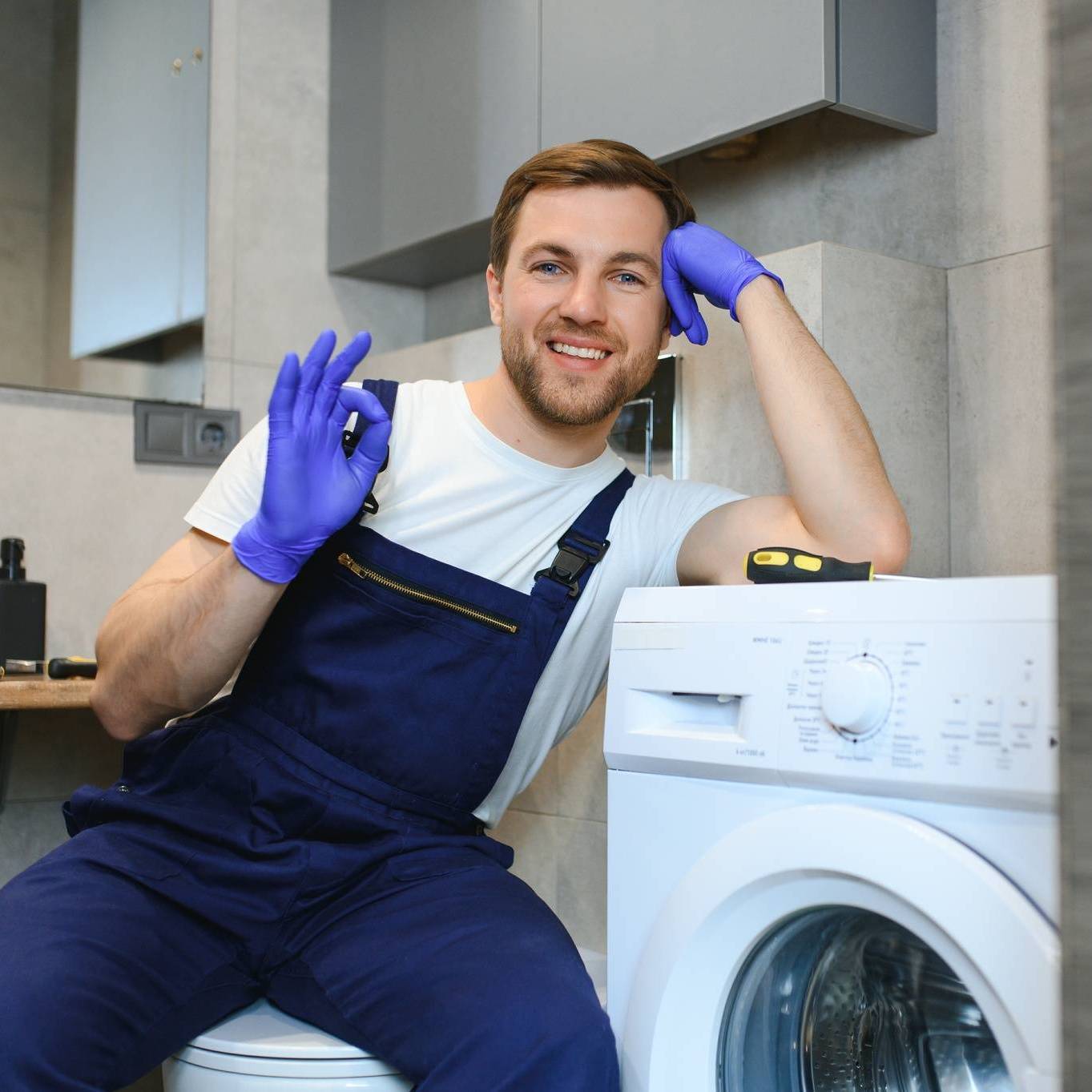 Xigent technician repairing washer in Salem OR